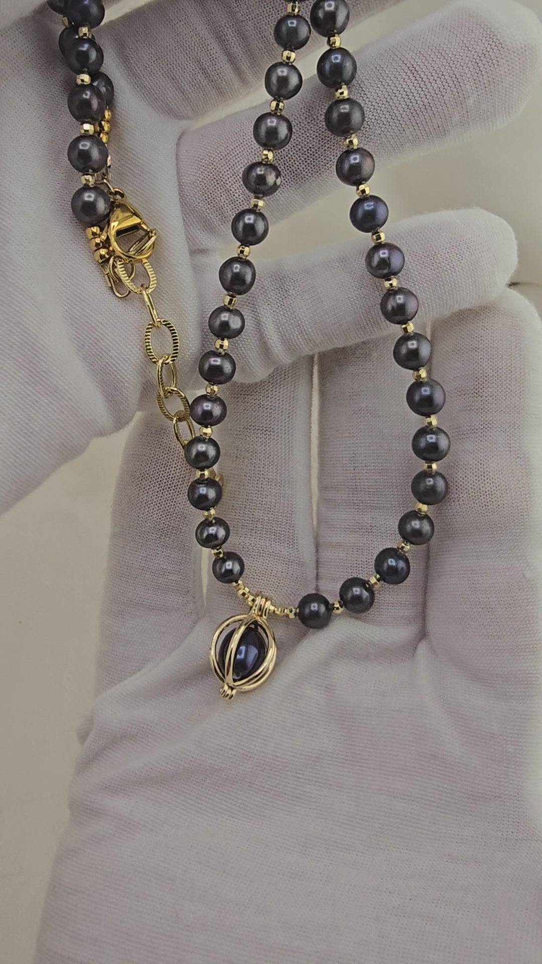 Black cultured pearl necklace in its case