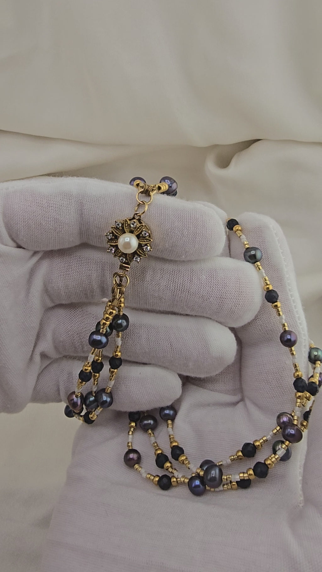3-row necklace of navy blue cultured pearls in its prestige box