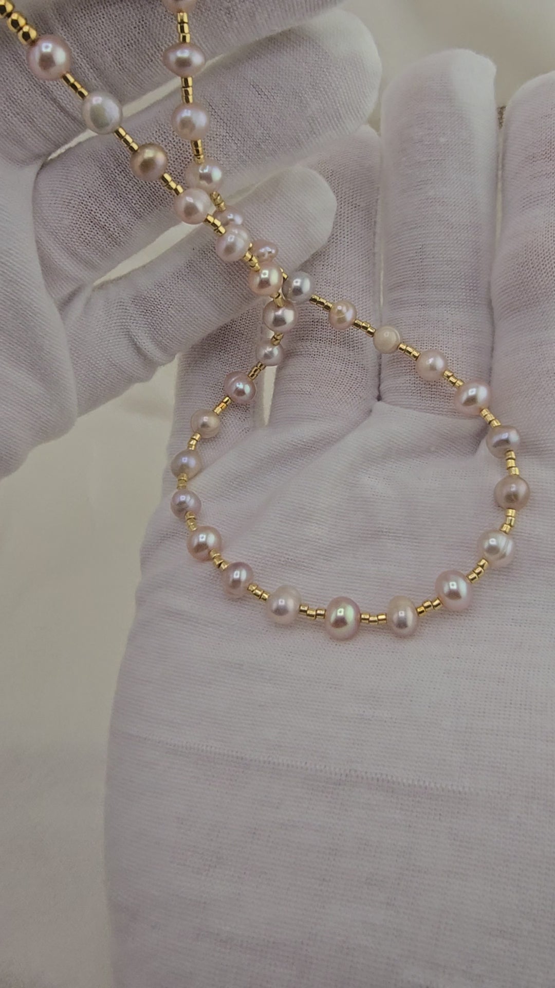 Pink cultured pearl choker necklace in its case