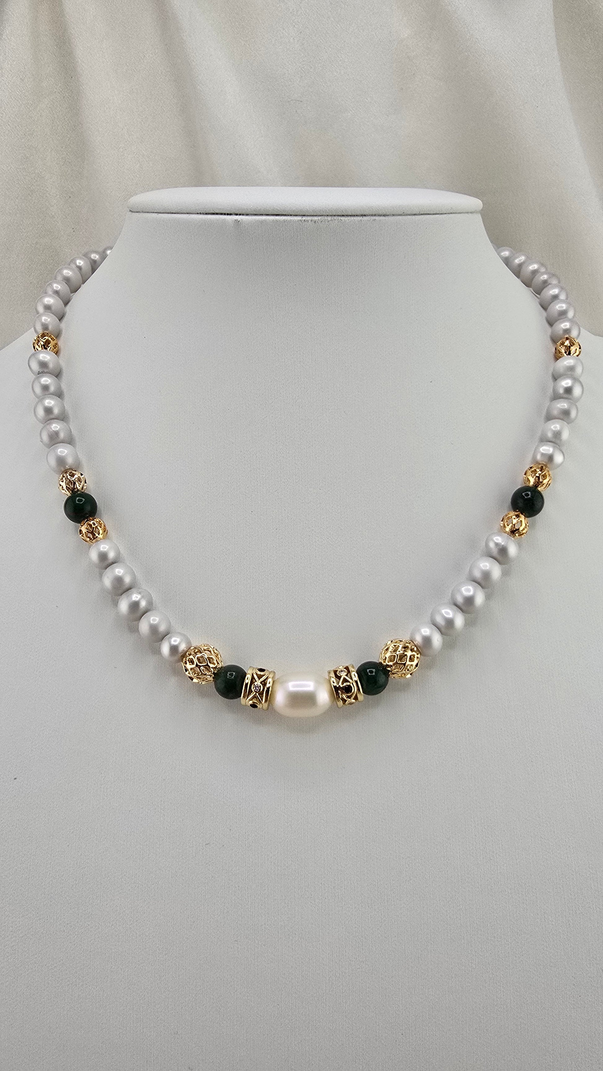 Cultured pearl and emerald necklace in its prestige box