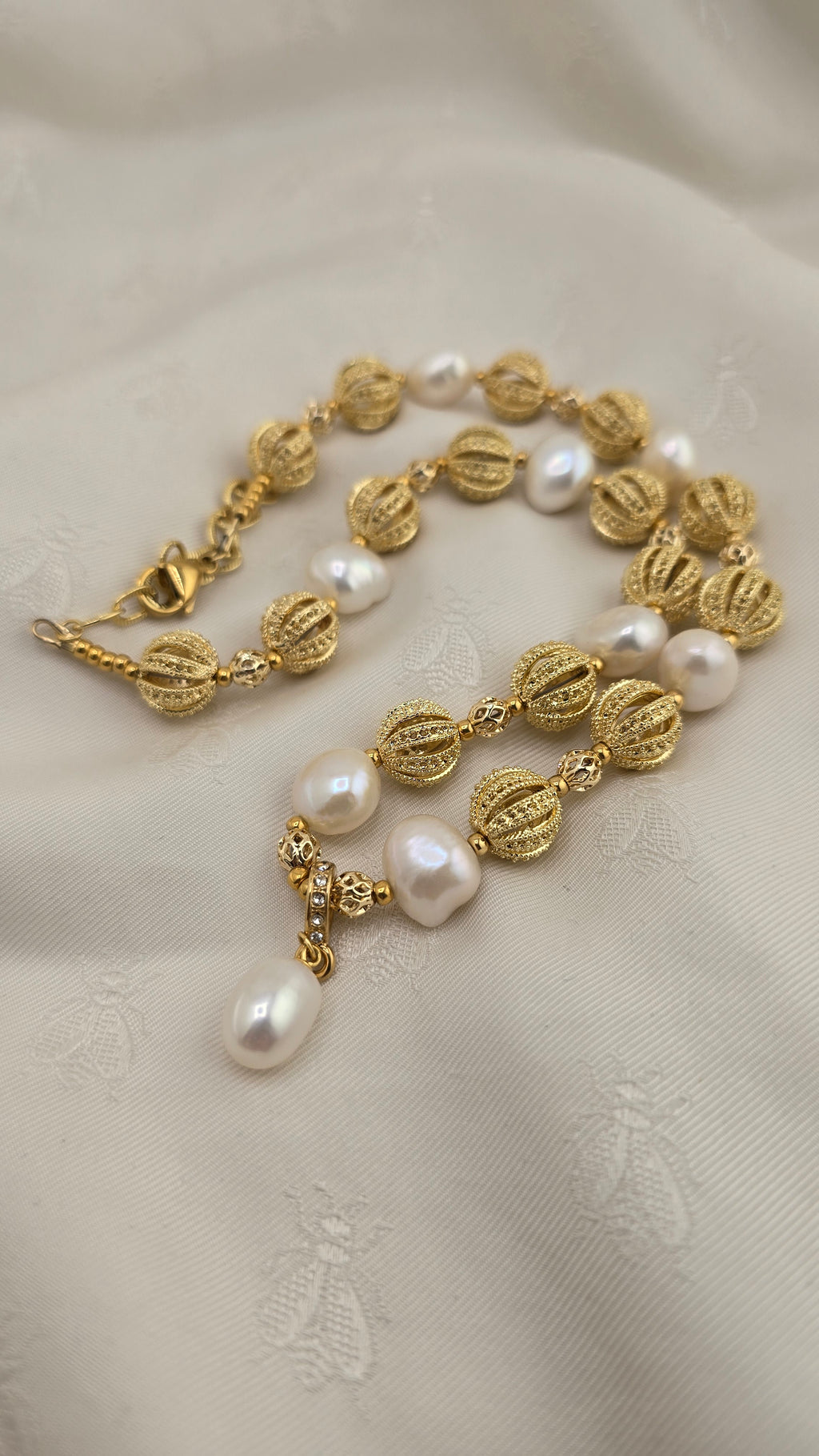 Necklace with baroque cultured pearls and olive cultured pearl pendant in its case