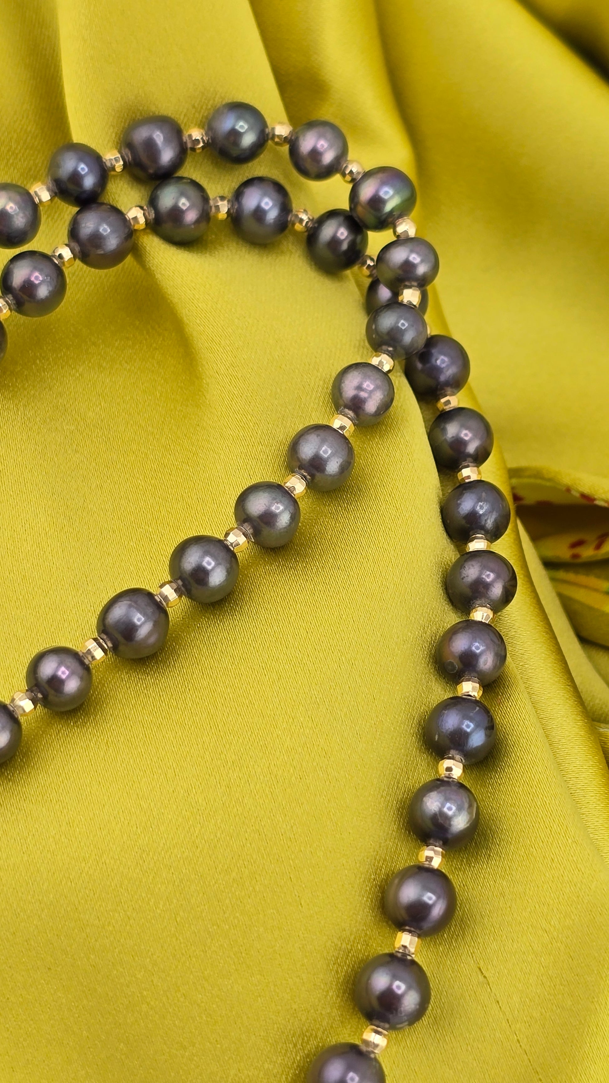 Black cultured pearl necklace in its case