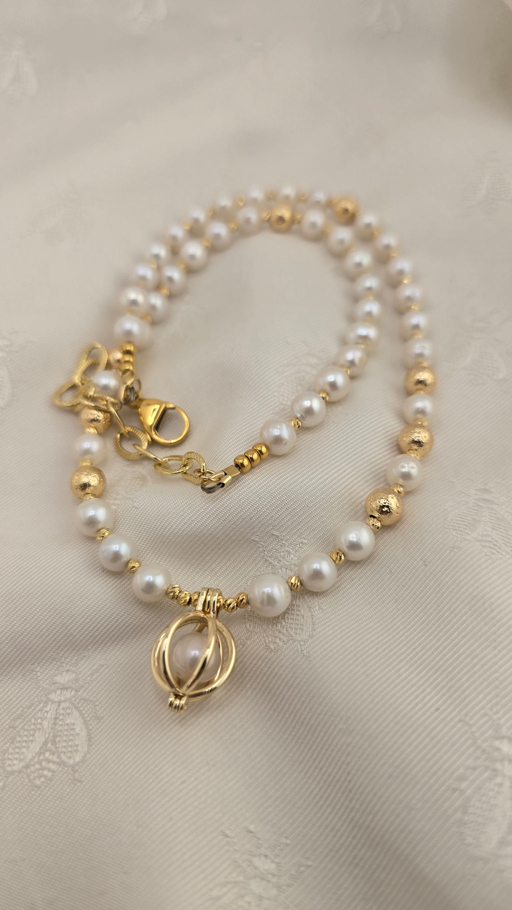 White cultured pearl necklace in its case