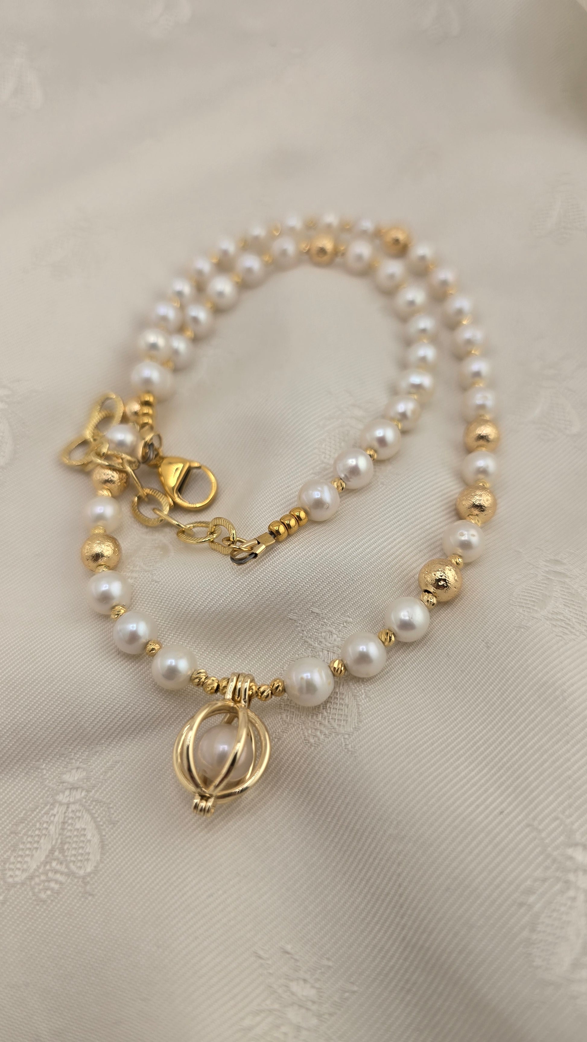 White cultured pearl necklace in its case