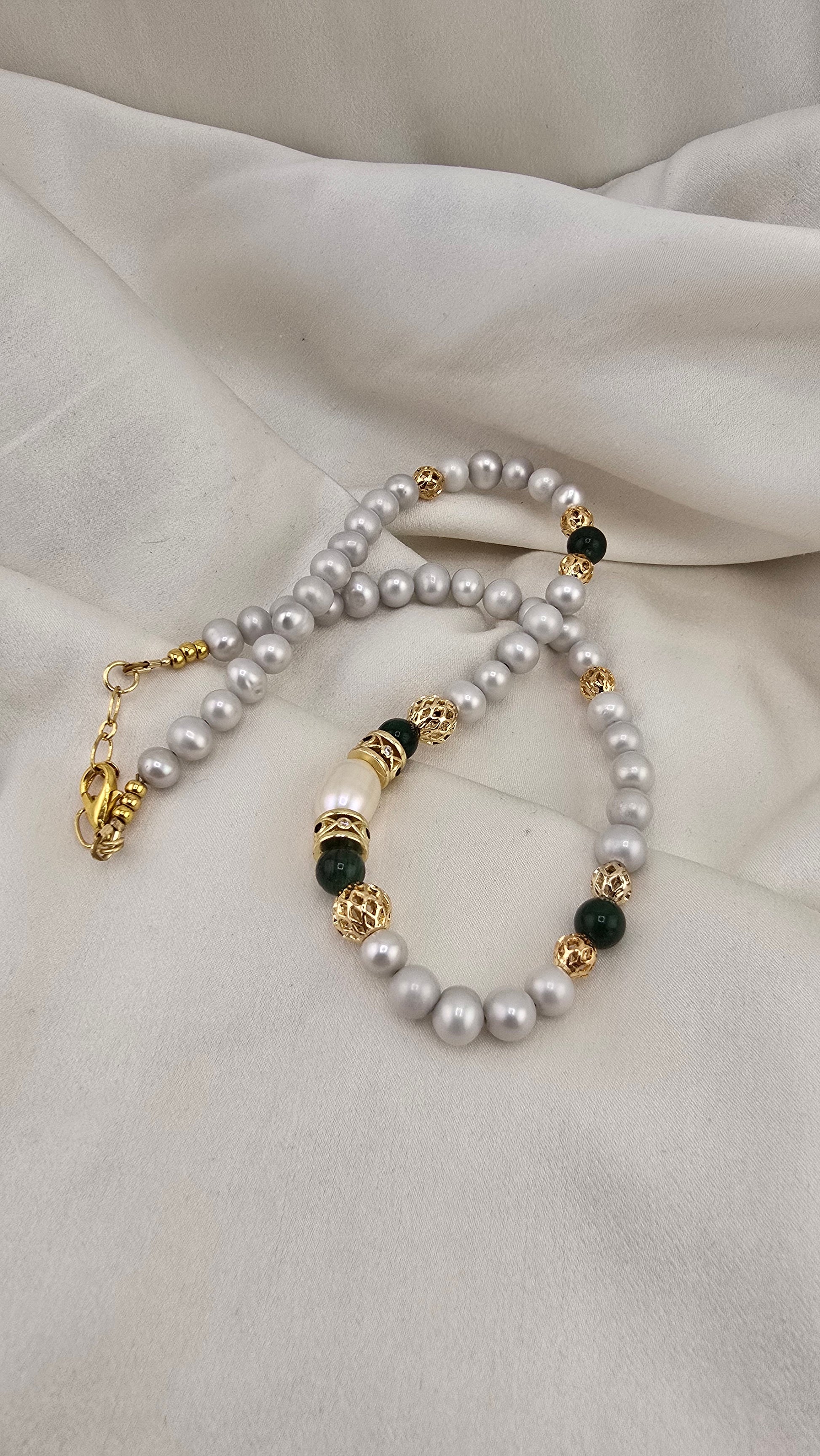 Cultured pearl and emerald necklace in its prestige box