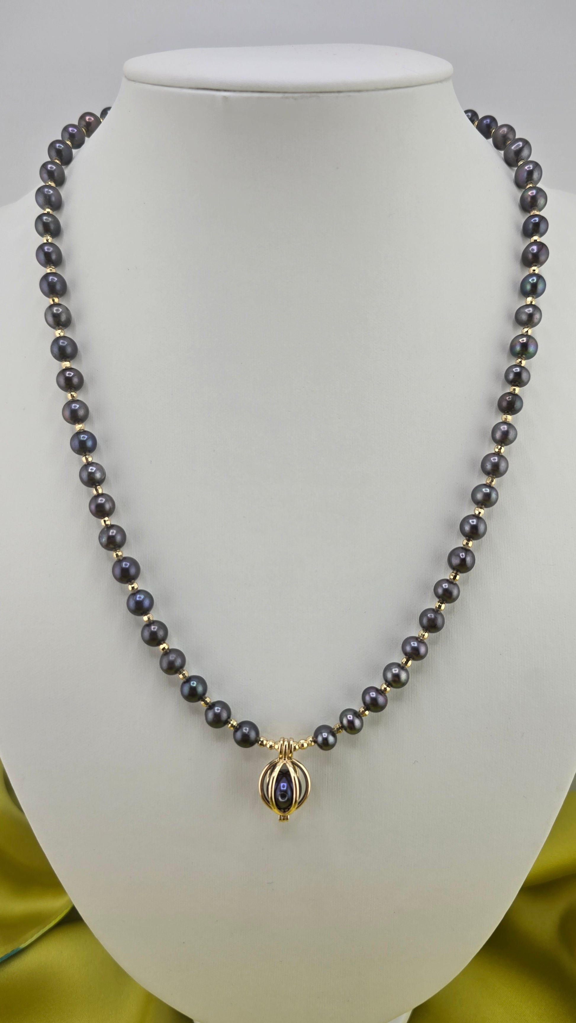 Black cultured pearl necklace in its case