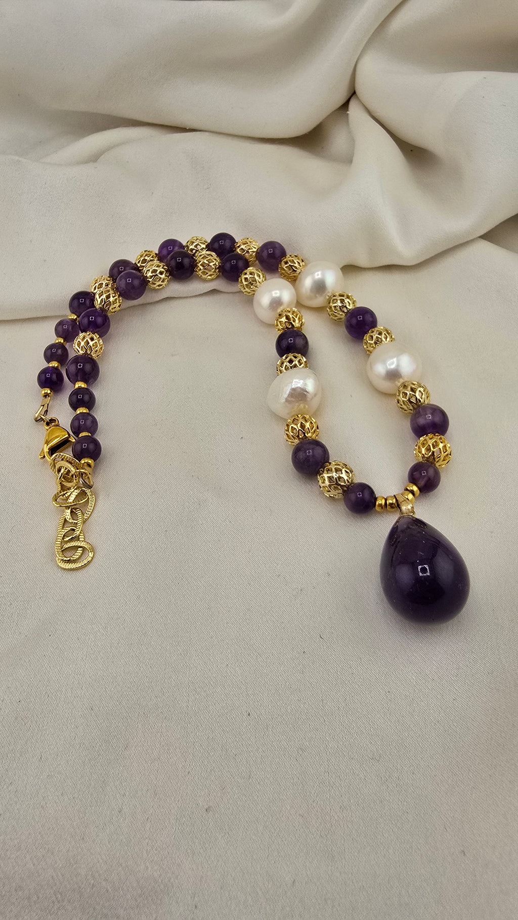Amethyst and baroque cultured pearl necklace in its case
