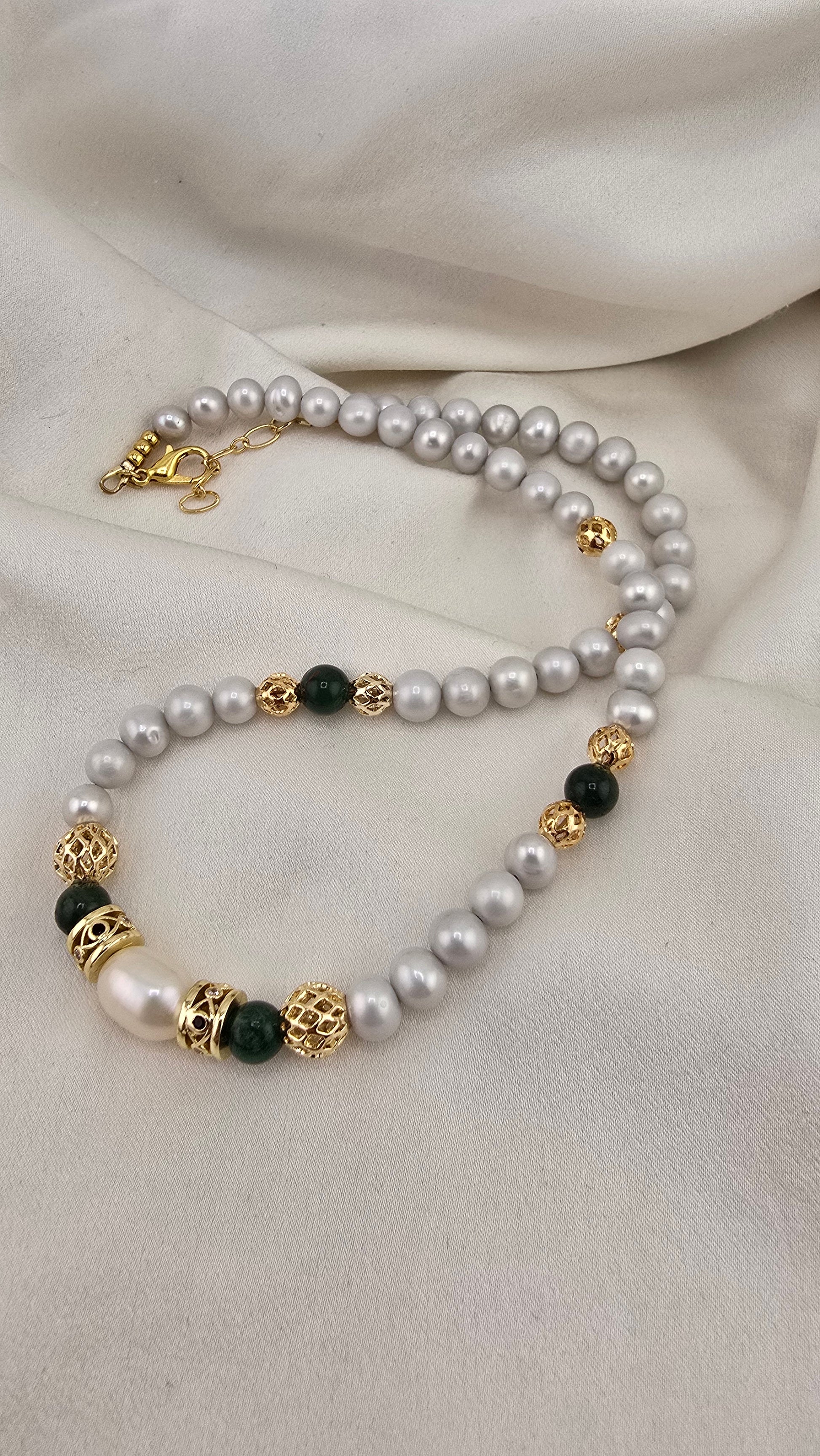 Cultured pearl and emerald necklace in its prestige box