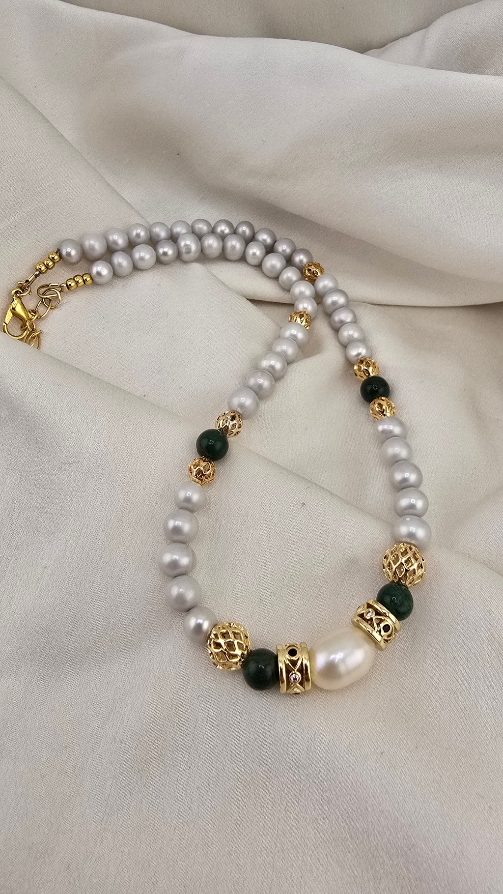 Cultured pearl and emerald necklace in its prestige box