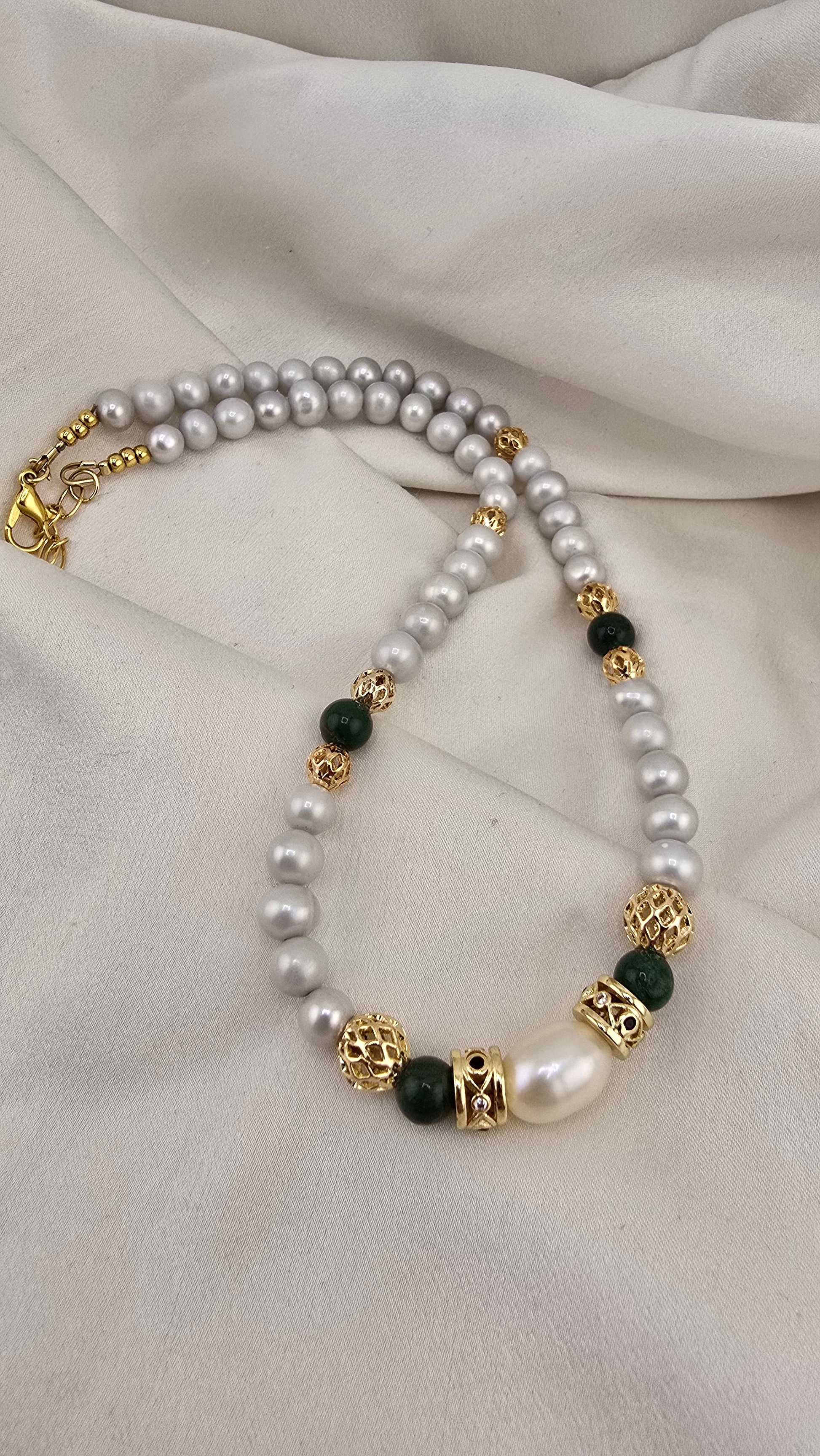 Cultured pearl and emerald necklace in its prestige box