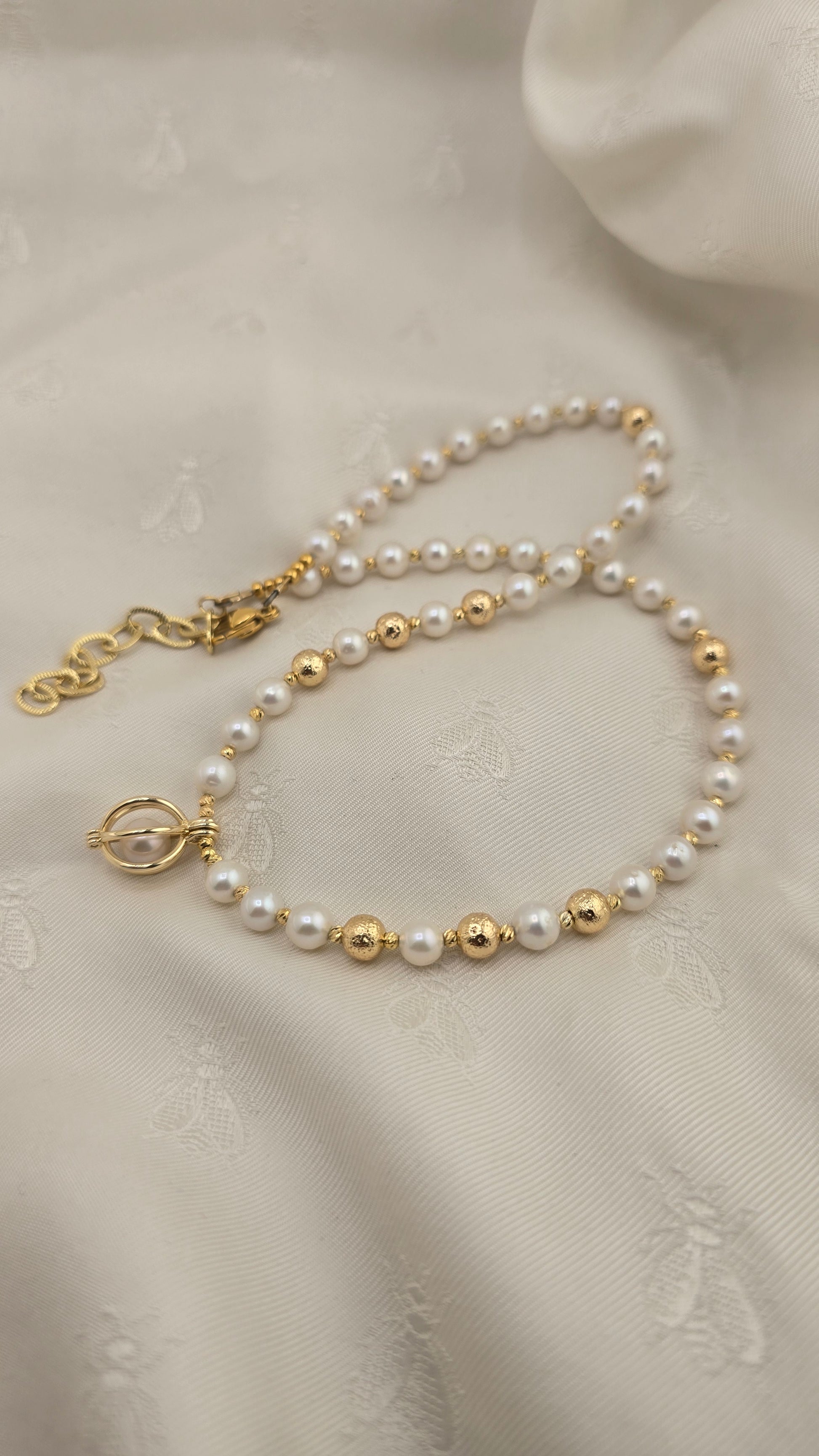 White cultured pearl necklace in its case