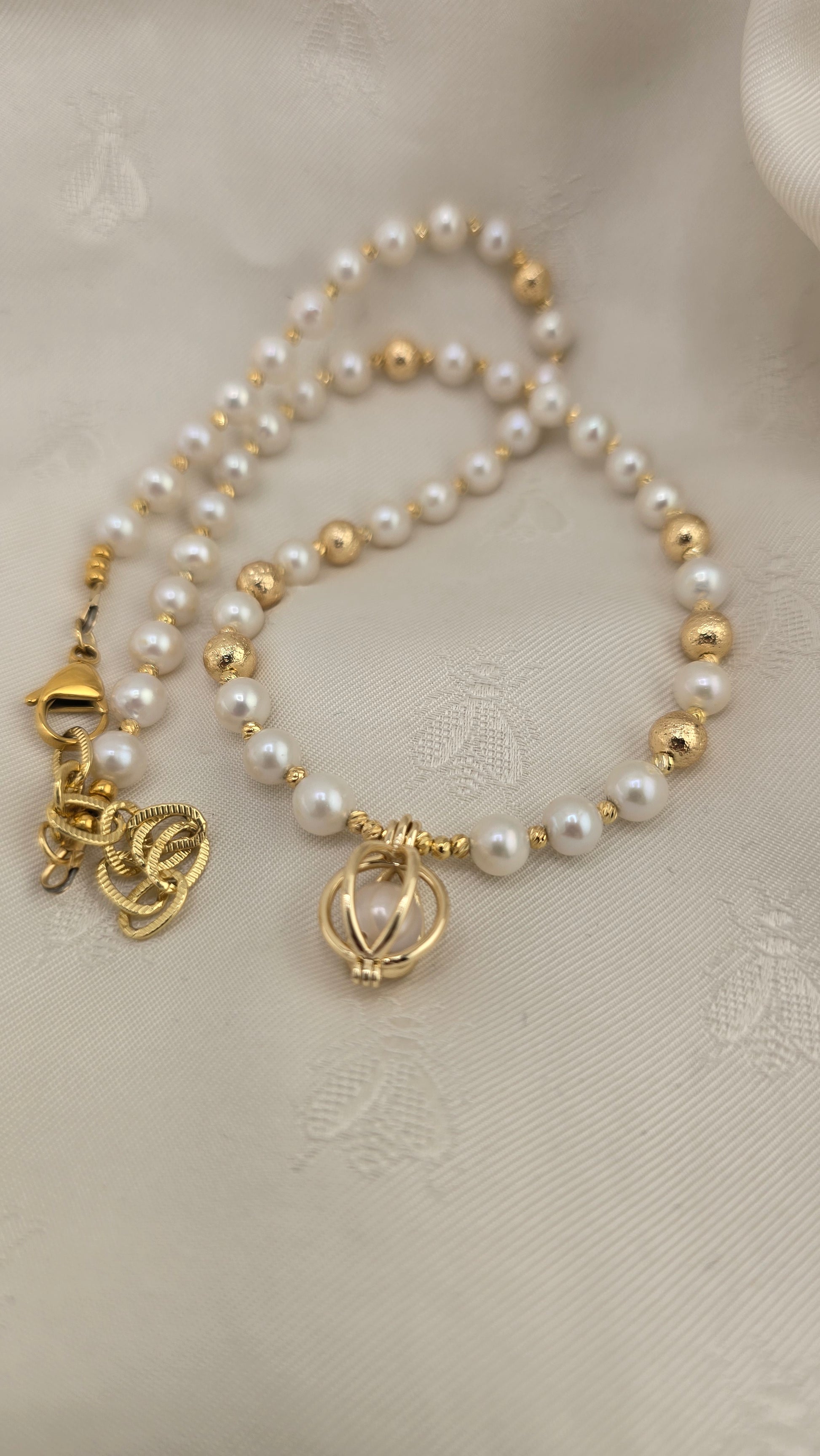 White cultured pearl necklace in its case