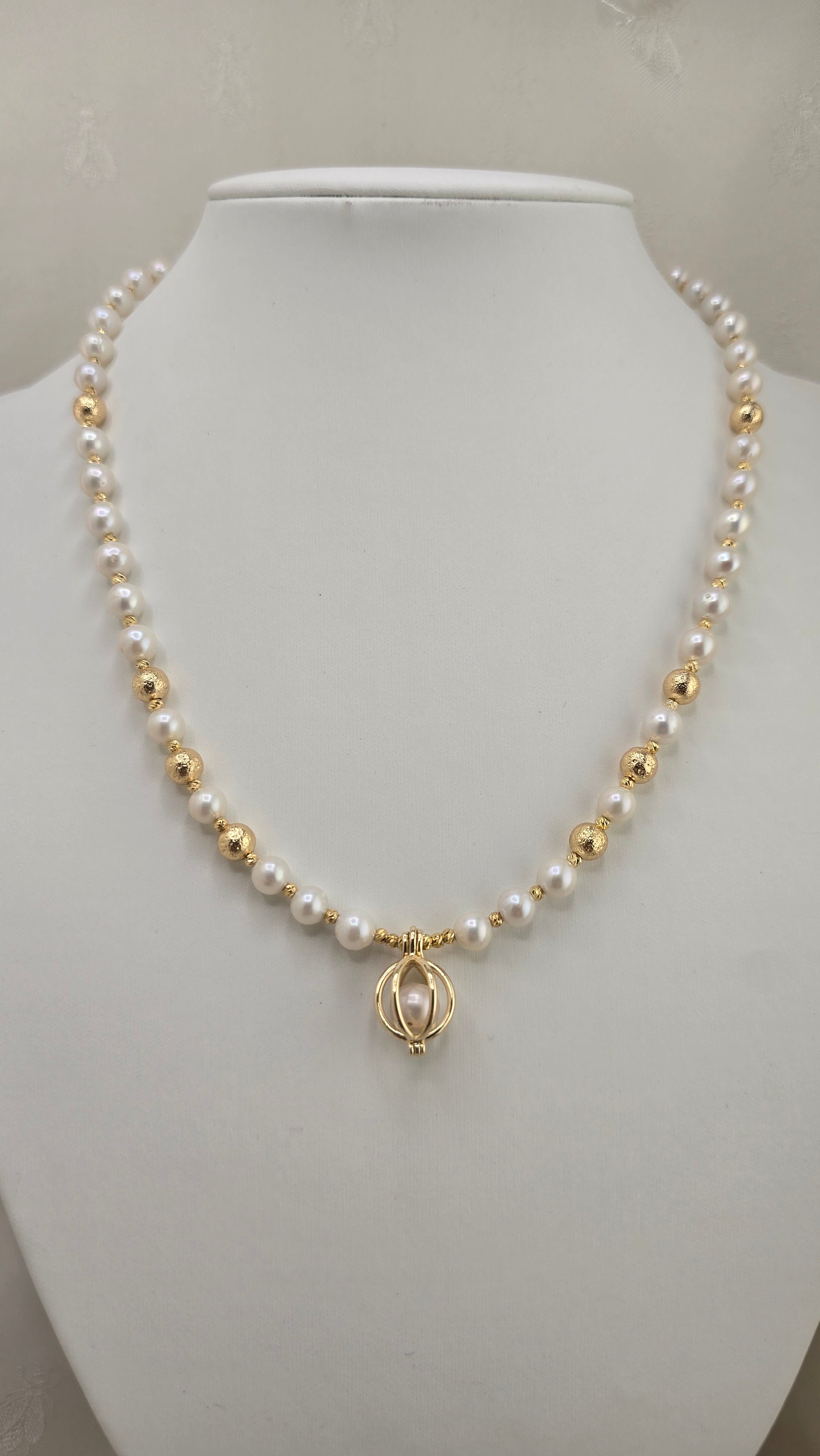 White cultured pearl necklace in its case