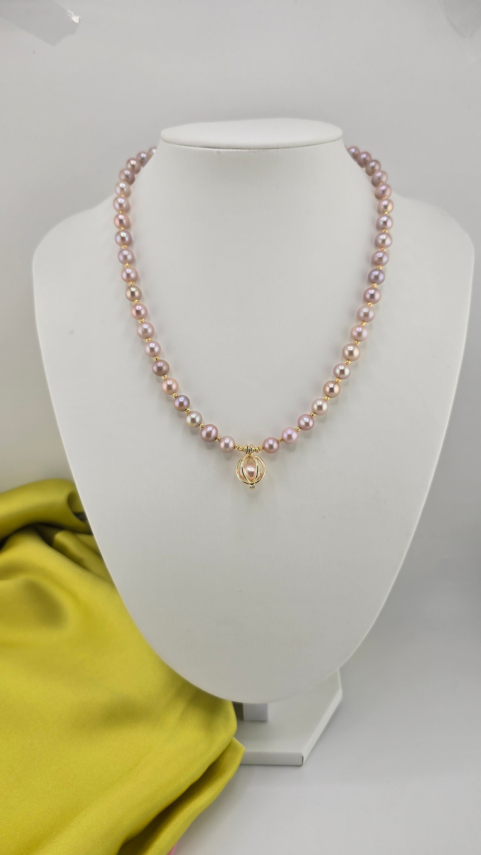 Pink cultured pearl necklace in its case