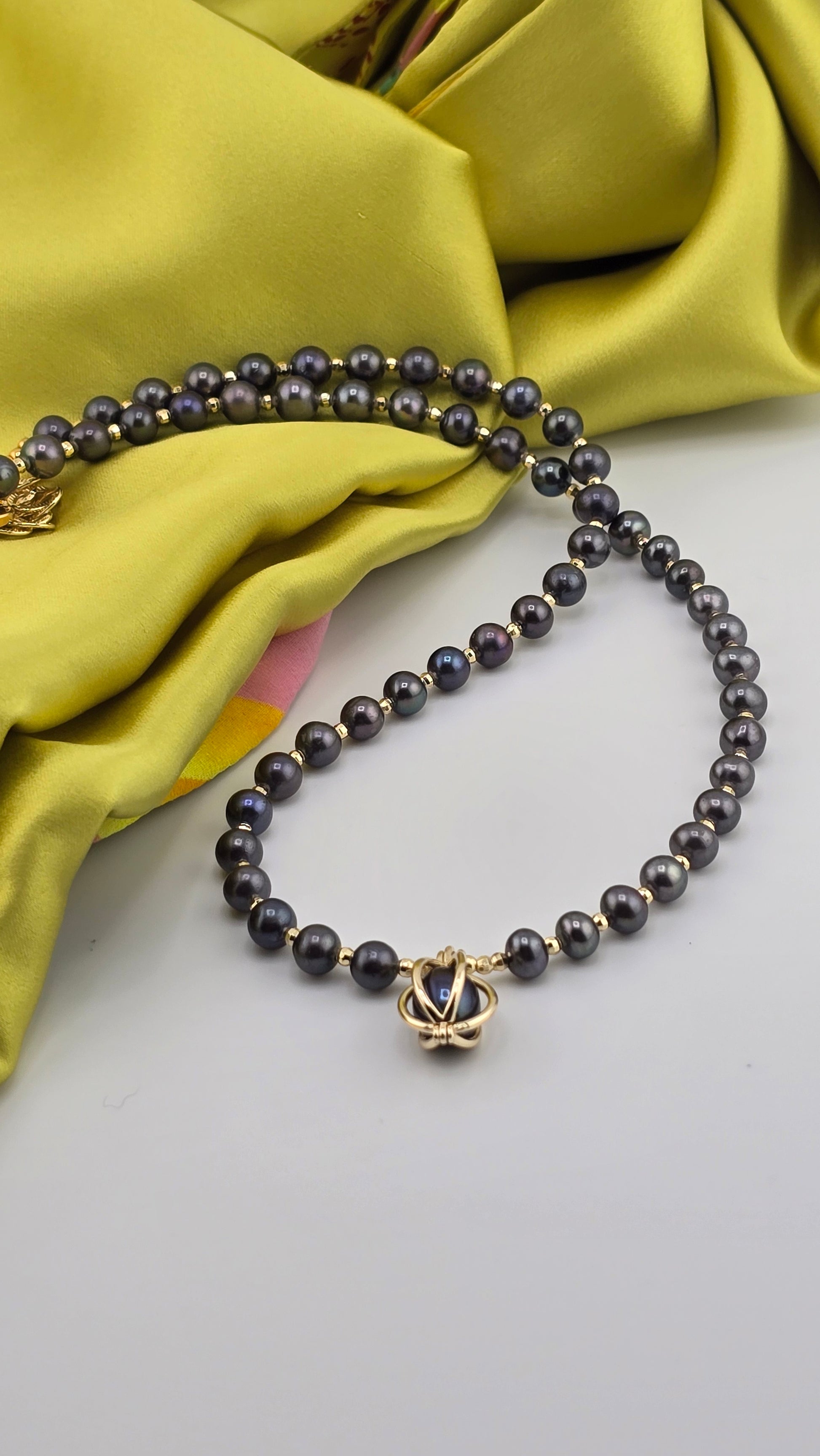 Black cultured pearl necklace in its case