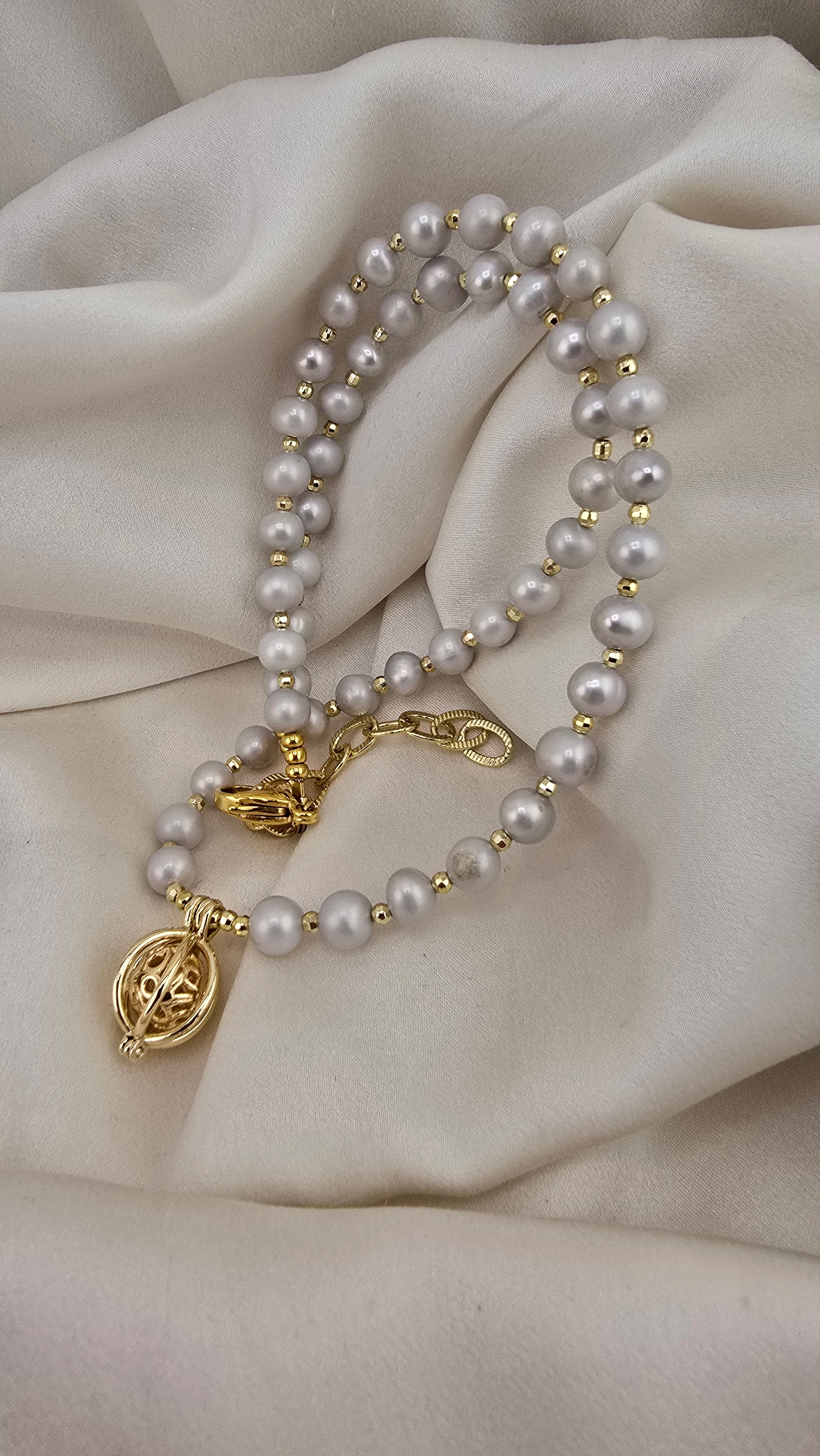 Gray cultured pearl necklace in its case