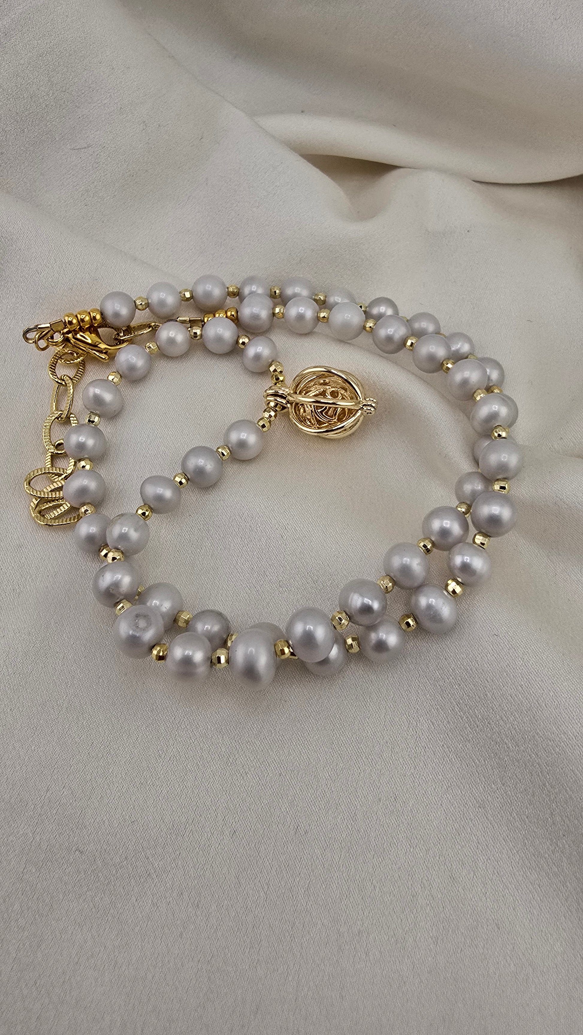 Gray cultured pearl necklace in its case
