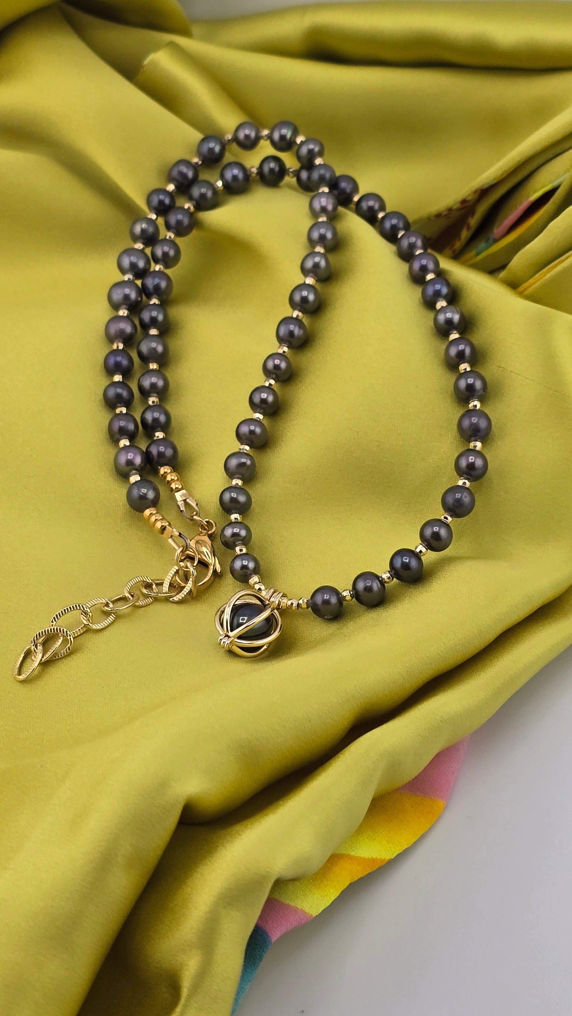 Black cultured pearl necklace in its case