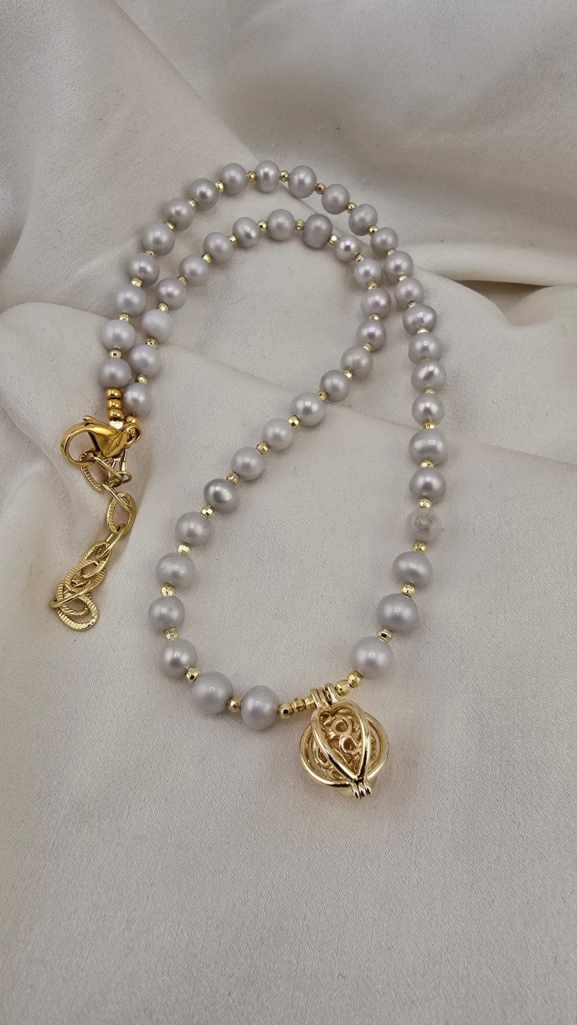 Gray cultured pearl necklace in its case