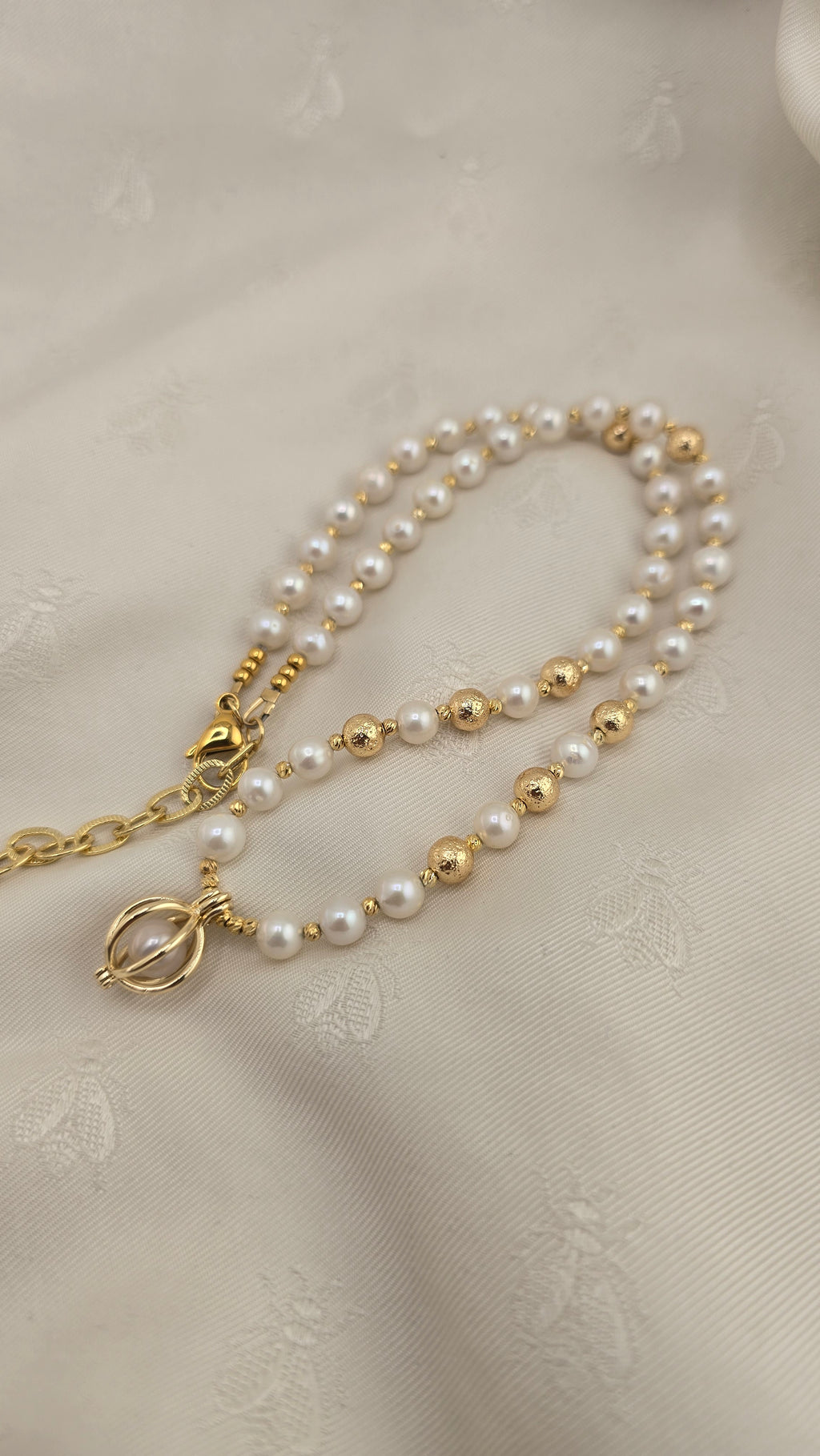 White cultured pearl necklace in its case