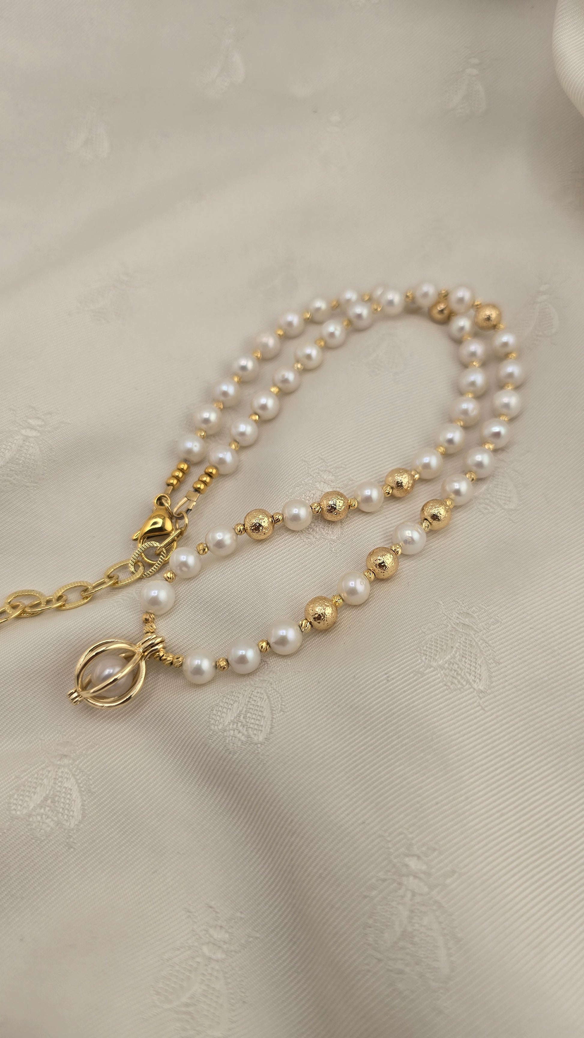 White cultured pearl necklace in its case